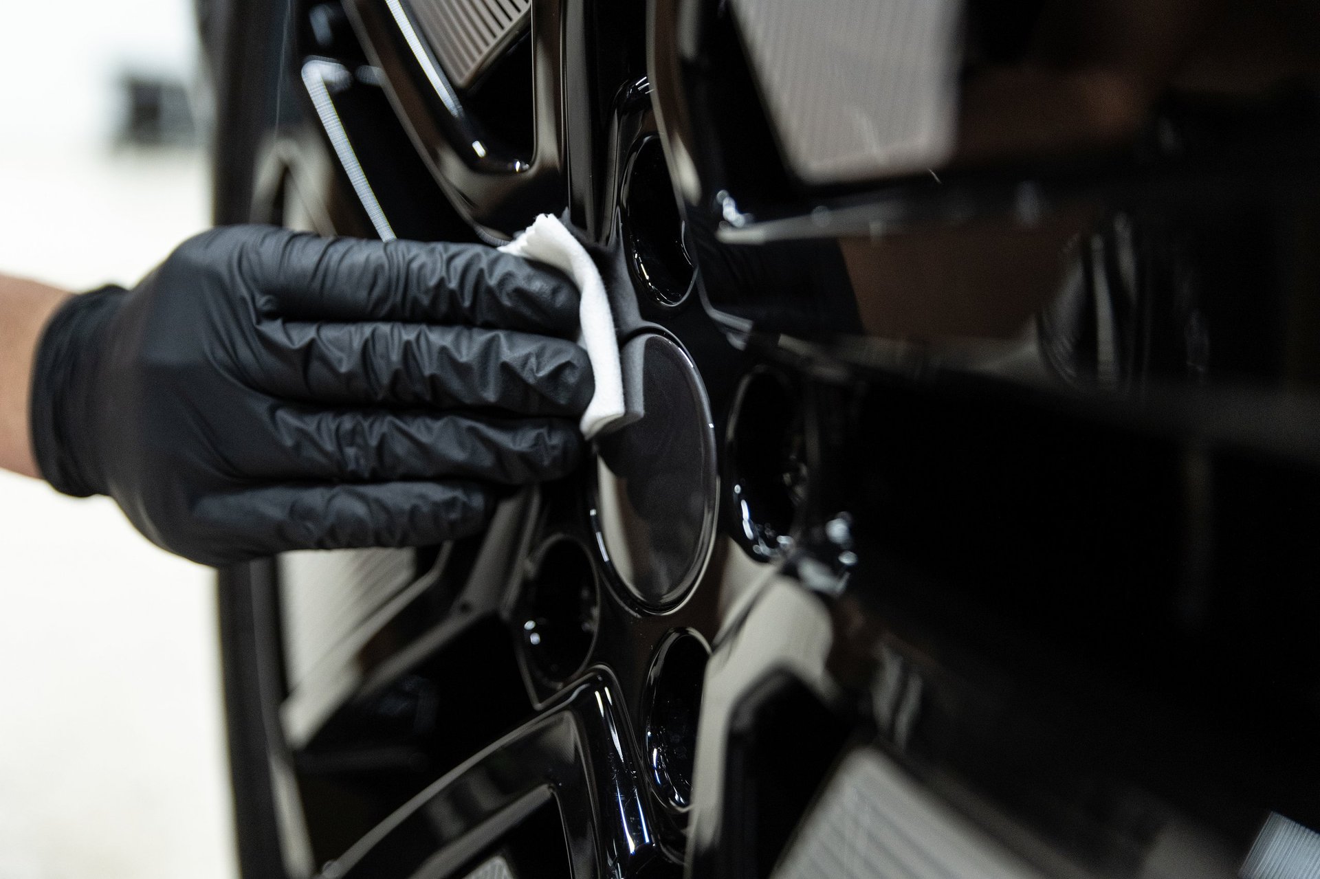 Ceramic coating on car wheel creating water beading effect and high-gloss finish